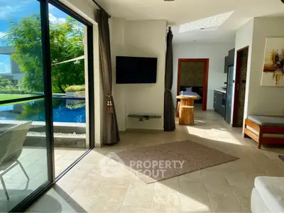 Luxurious living room with pool view and modern decor in a stylish home