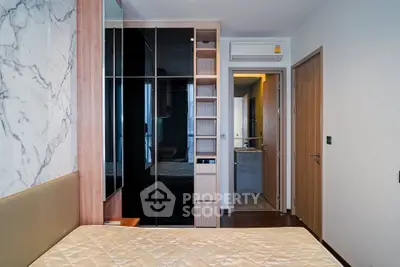 Modern bedroom with built-in wardrobe and marble accent wall