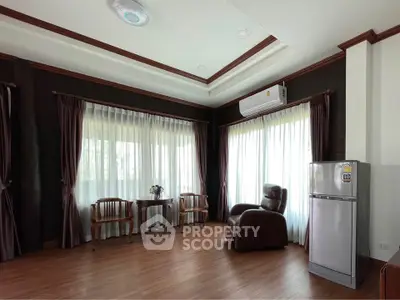 Spacious living room with elegant wooden flooring and modern furniture