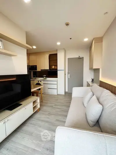 Modern living room with open kitchen layout and stylish decor