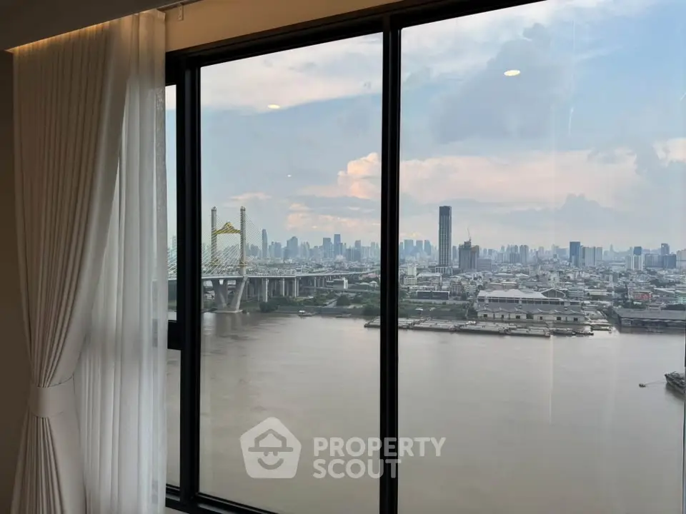 Stunning river view from high-rise apartment window with city skyline