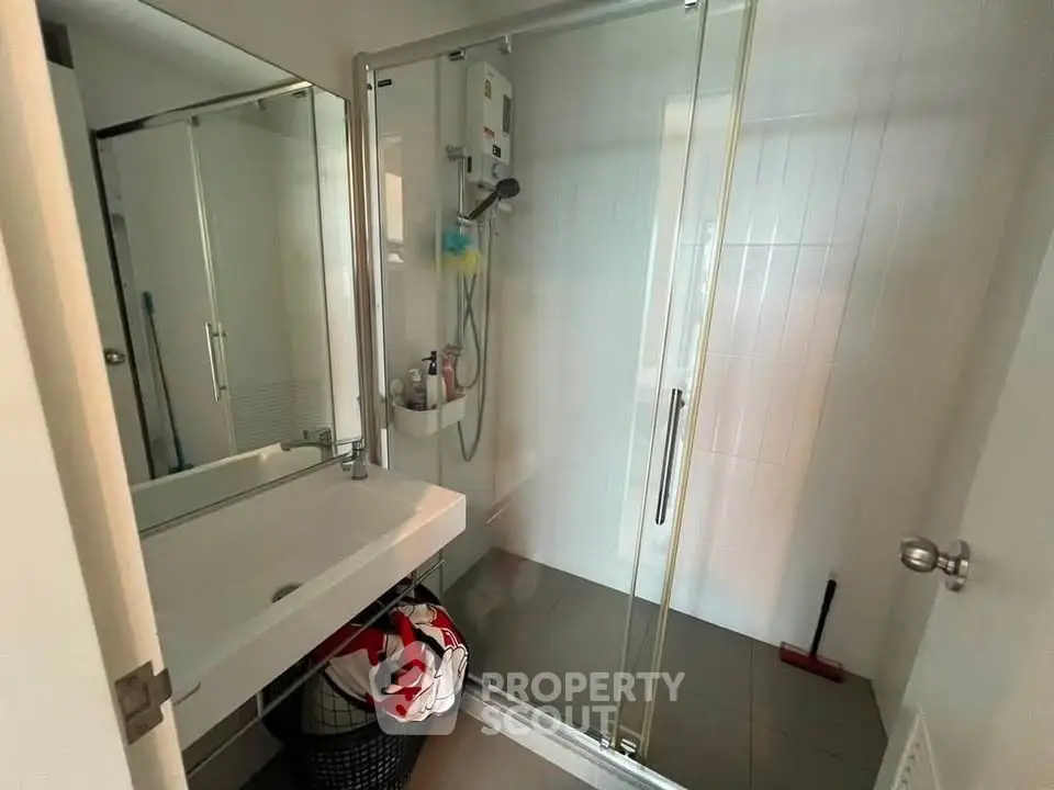 Modern bathroom with glass shower enclosure and sleek vanity