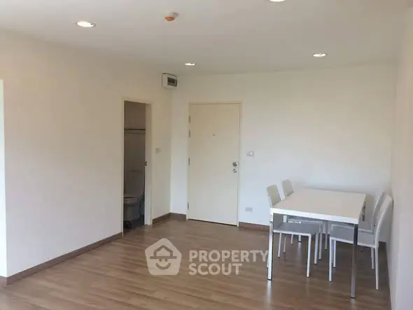 Spacious minimalist living room with dining area and wooden flooring