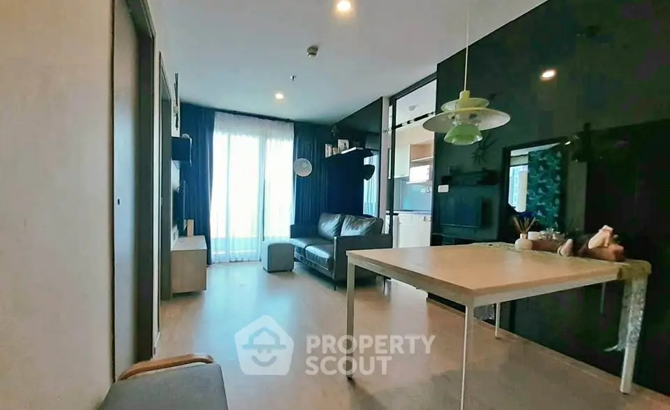 Modern living room with sleek design and natural light, featuring a cozy sofa and stylish decor.