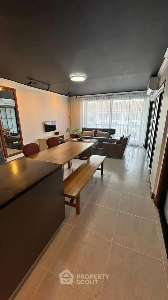 Spacious modern living room with stylish furniture and large windows for natural light.