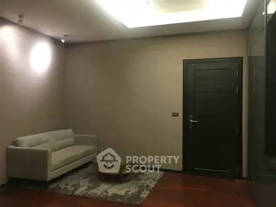 Modern living room with sleek sofa and stylish coffee table on wooden flooring.