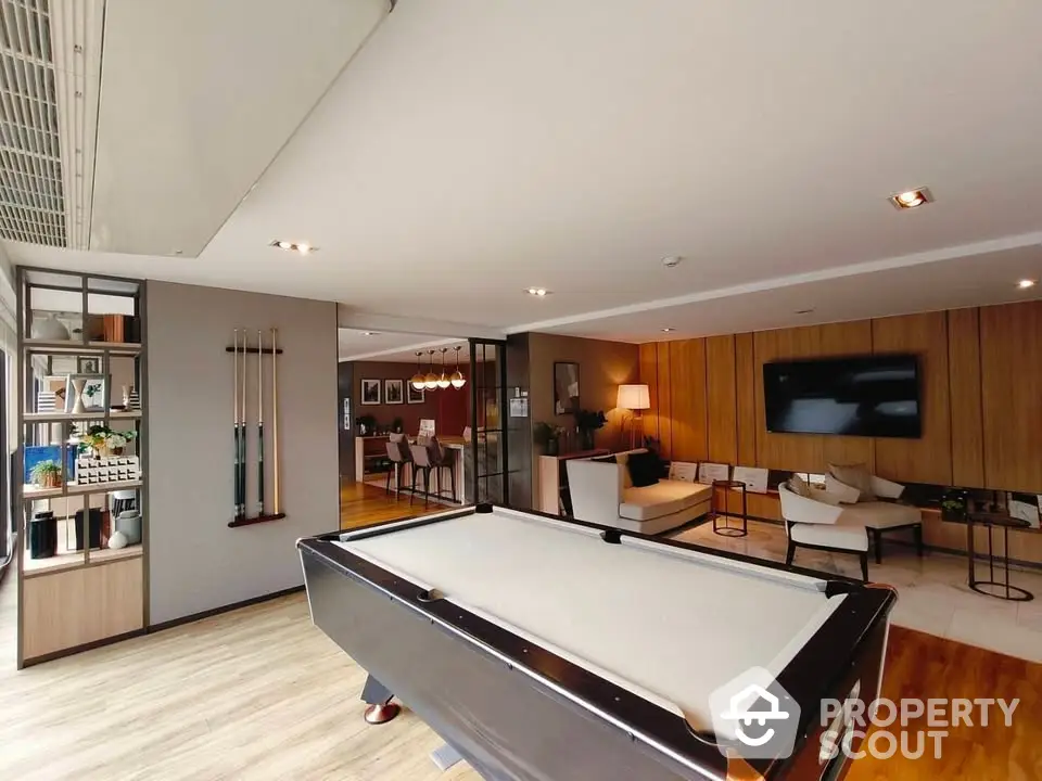 Luxurious living room with pool table and modern decor, perfect for entertainment and relaxation.