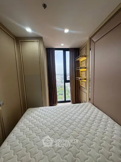 Cozy bedroom with large window offering stunning city view and modern lighting.