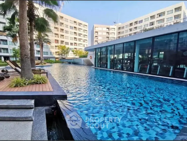 Luxurious apartment complex with stunning pool and modern architecture.