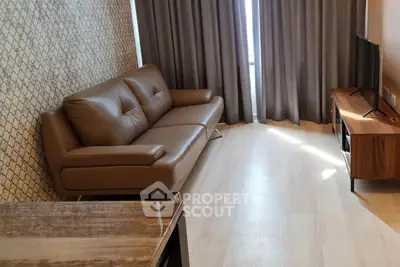 Modern living room with stylish brown leather sofa and elegant decor