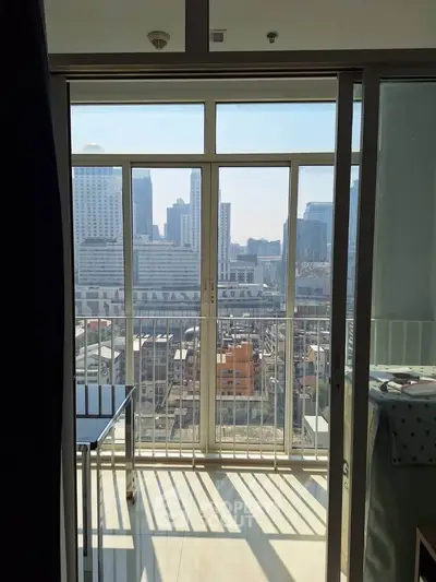Modern apartment with balcony offering stunning city skyline views, perfect for urban living.