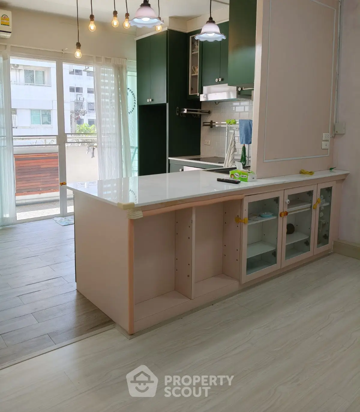 Modern kitchen with open layout and stylish lighting in a bright apartment.