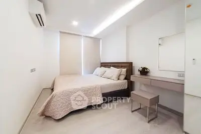 Modern minimalist bedroom with sleek design and natural light, featuring a cozy bed and stylish decor.