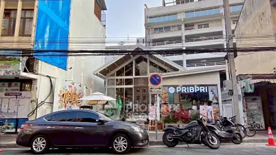 Charming urban cafe with modern facade and street view, perfect for business or leisure in bustling city area.