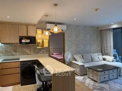 Modern open-plan living room and kitchen with stylish decor and cozy ambiance.