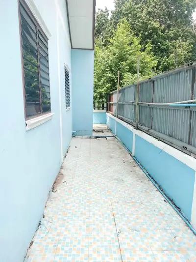 Spacious outdoor balcony with tiled flooring and lush greenery view