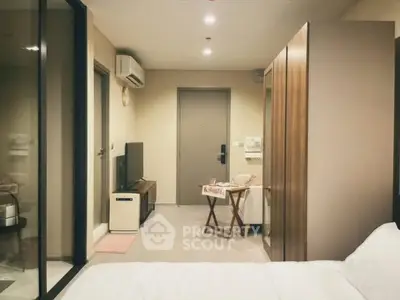 Modern studio apartment with cozy living area and sleek design