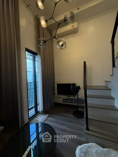 Modern duplex living room with high ceiling and stylish lighting
