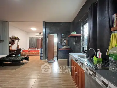 Spacious open-layout living area with modern kitchen and cozy dining space