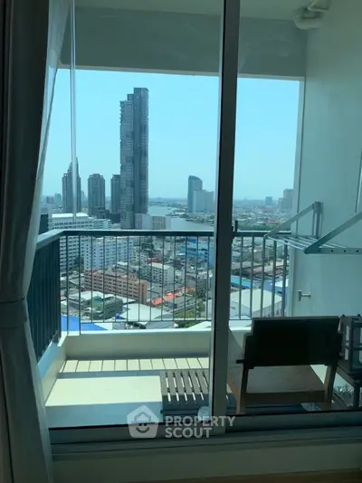 Stunning cityscape view from a modern balcony with sleek glass railing, perfect for urban living.