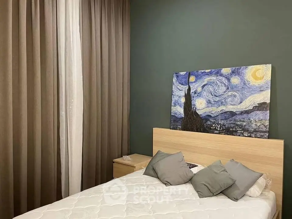 Cozy bedroom with elegant decor and Van Gogh artwork, featuring plush bedding and stylish curtains.