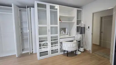 Spacious bedroom with modern white wardrobe and vanity set