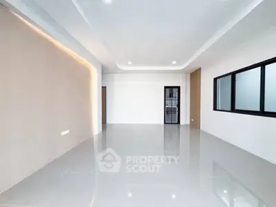 Spacious modern living room with sleek tile flooring and large windows