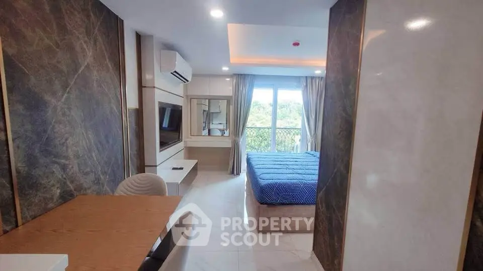 Modern bedroom with elegant decor and large window offering scenic views