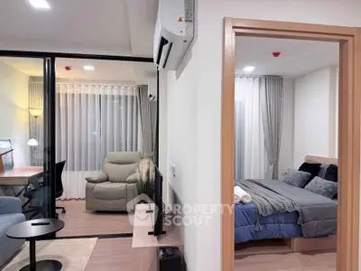 Modern apartment interior with cozy living room and stylish bedroom, featuring sleek furniture and elegant decor.