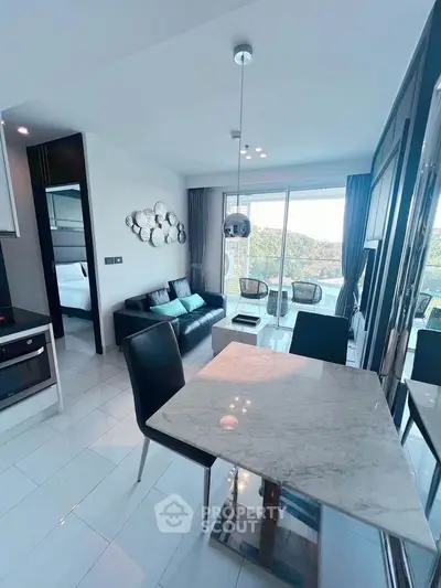 Modern open-plan living room with dining area and scenic balcony view