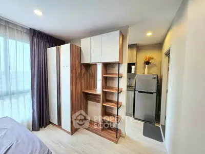 Modern bedroom with stylish wardrobe and compact kitchen area