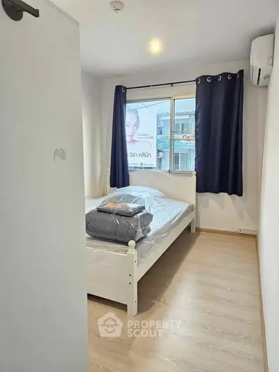 Cozy bedroom with natural light and modern furnishings in urban apartment