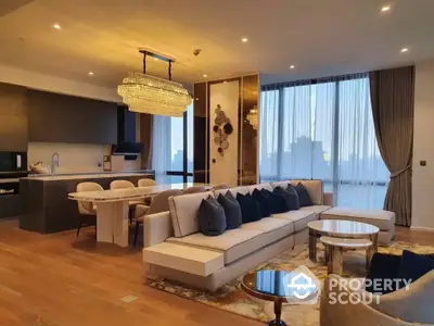 Luxurious open-plan living space with modern furnishings, elegant chandelier, and expansive city views through floor-to-ceiling windows, perfect for upscale urban living.