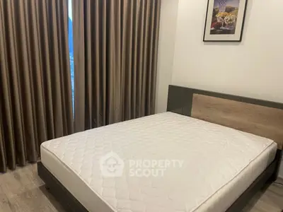 Modern bedroom with stylish bed and elegant curtains in a cozy apartment.