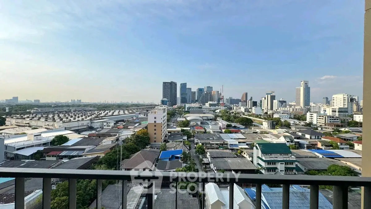 Stunning cityscape view from a high-rise balcony overlooking urban skyline and residential area.