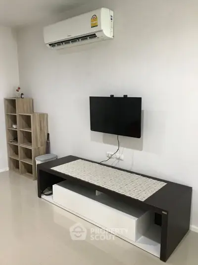 Modern living room with wall-mounted TV and sleek air conditioning unit.