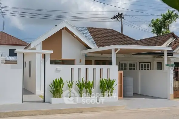 Charming modern house with sleek design and lush greenery in a serene neighborhood.