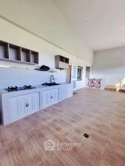 Spacious open-layout kitchen with modern design and ample natural light