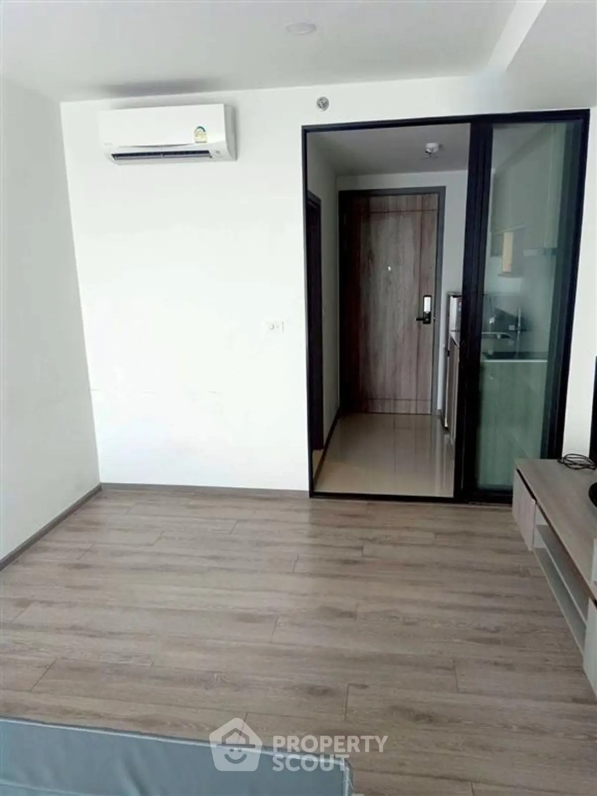 Modern minimalist living room with wooden flooring and air conditioning