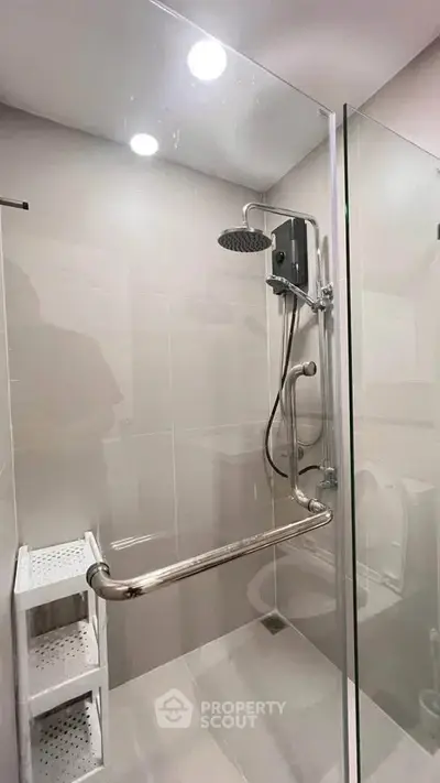 Modern bathroom with glass shower enclosure and sleek fixtures