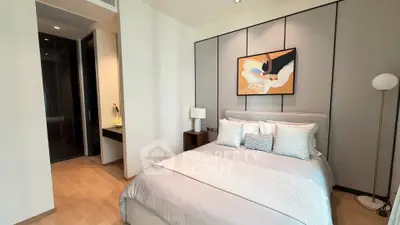 Elegant bedroom with modern decor and cozy ambiance in a luxury apartment.