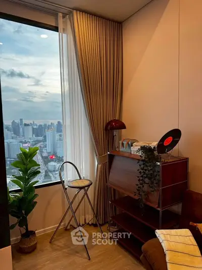 Stylish living room with panoramic city view, elegant decor, and cozy ambiance.