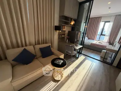 Modern apartment with cozy living room and stylish bedroom, featuring elegant decor and natural light.