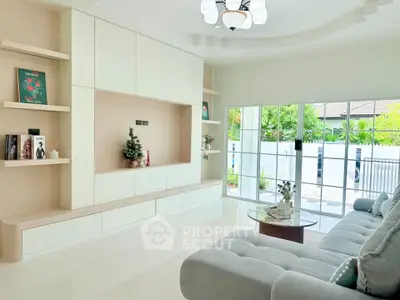 Modern living room with large windows, cozy sectional sofa, and built-in shelving for stylish decor.