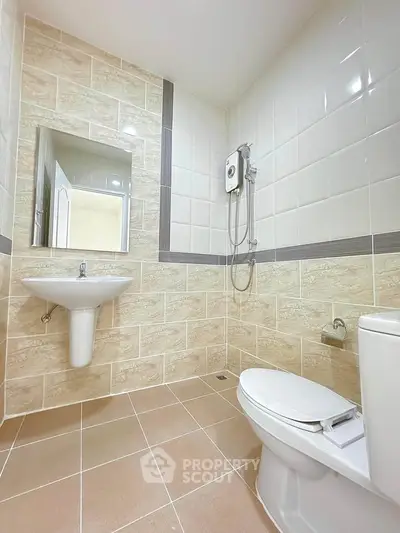 Modern bathroom with sleek fixtures and tiled walls, featuring a shower and toilet.