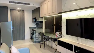 Modern living room with sleek furniture and integrated kitchen appliances