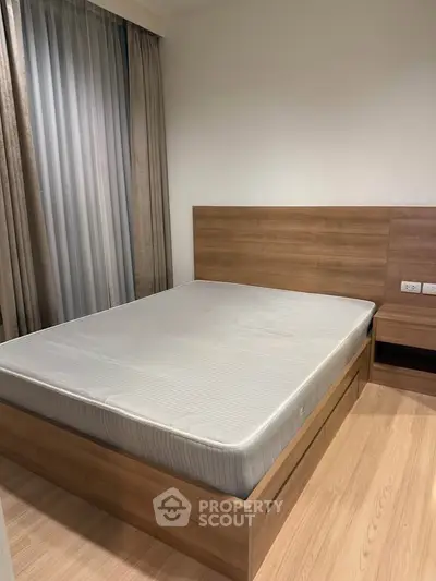Modern bedroom with wooden bed frame and large window curtains