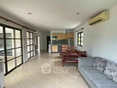 Spacious open-plan living room with modern kitchen and stylish furniture