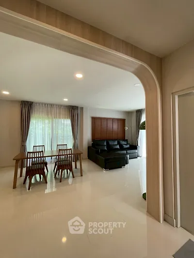 Spacious modern living room with elegant dining area and natural light