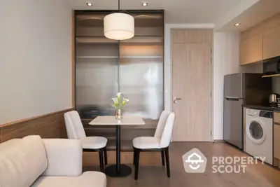 Modern dining area with elegant chairs and table in a cozy apartment setting.